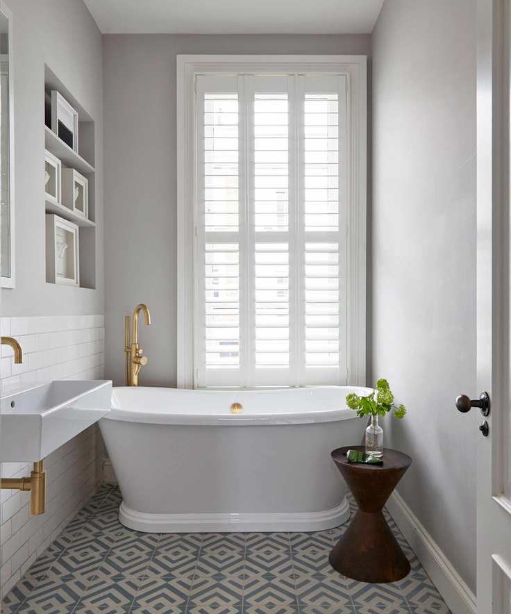 A compact white bathroom with geometric tiles
