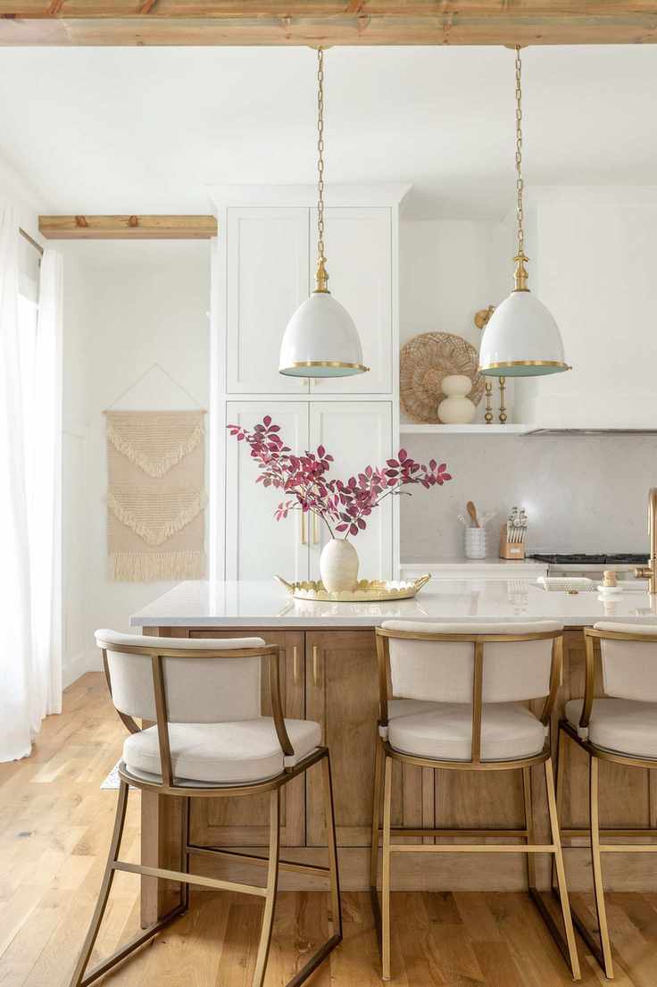 modern farmhouse kitchen with island and white chairs with white pendant lights
