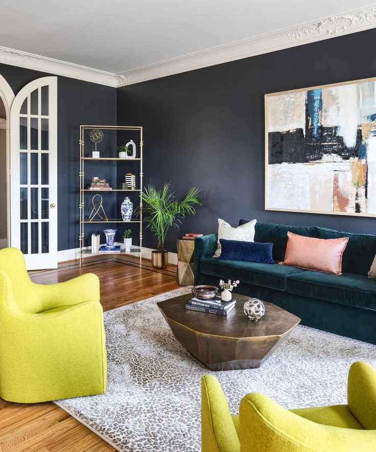 Living room painted navy blue with contrasting white plaster moulding