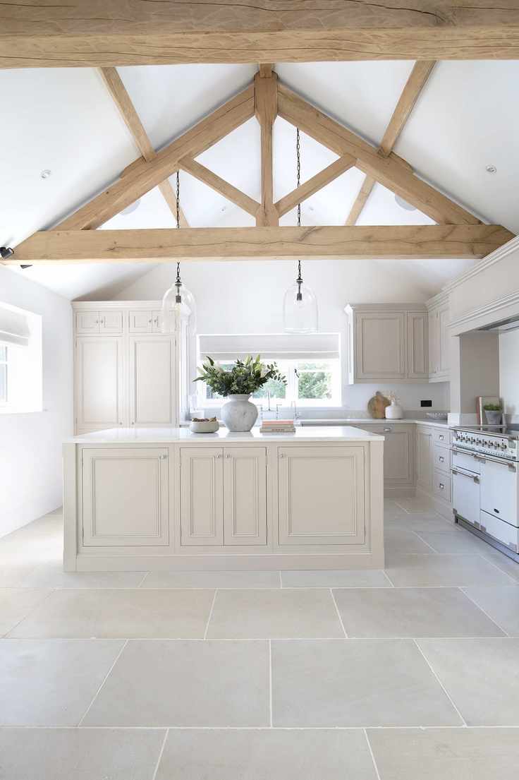 Sandstone floor in a kitchen with wooden beamed ceiling