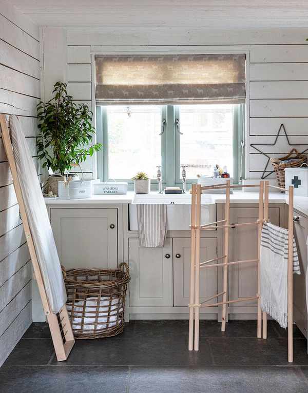 Laundry room with shiplap paneling and gray slate flooring.