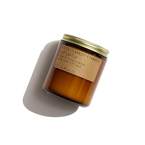 An amber glass jar with a brown paper label and gold screw on lid
