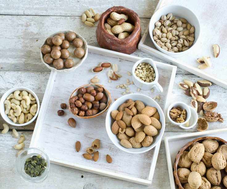 A variety of nuts in glass dishes