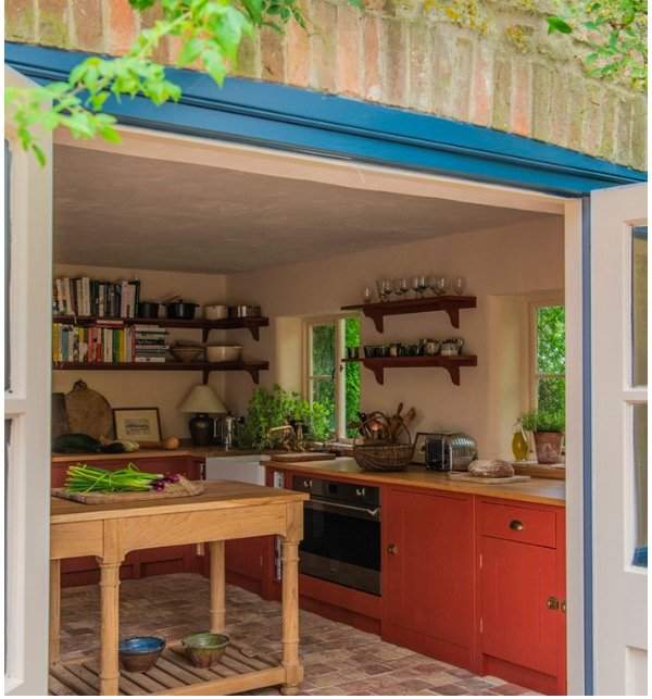 Red kitchen with plaster pink walls