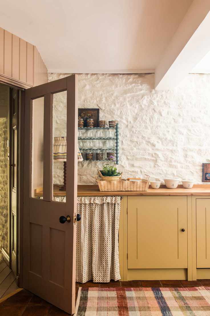 country style cabinetry in yellow, with curtain