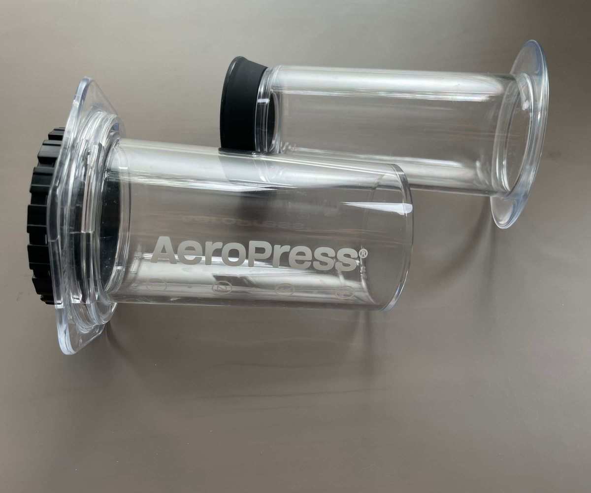 A clear AeroPress in parts on a table, ready to use to make the perfect AeroPress coffee