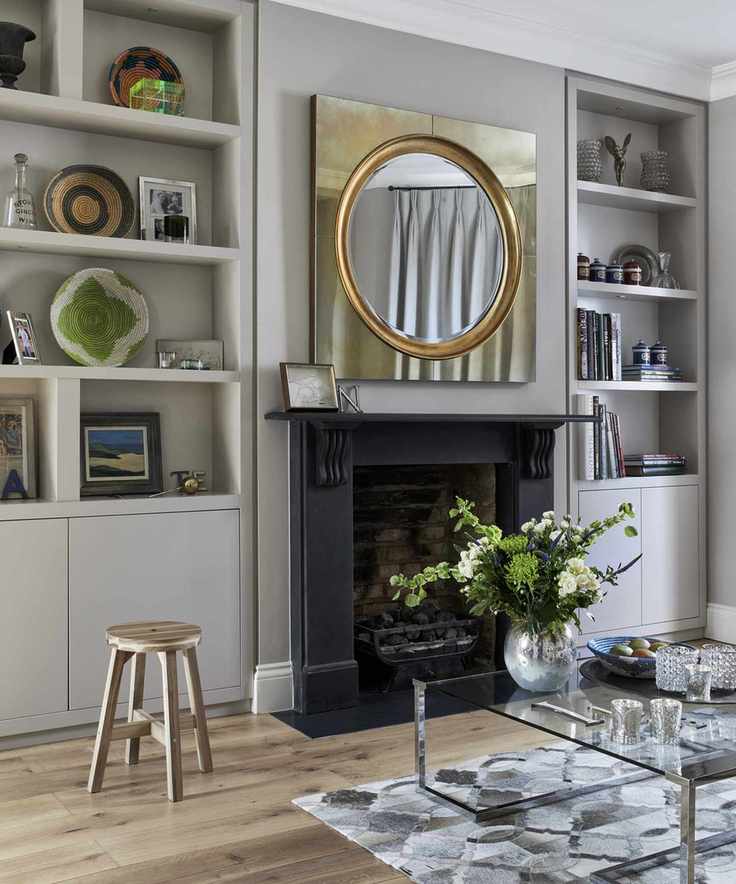 Circular mirror with a square gold frame in the living room