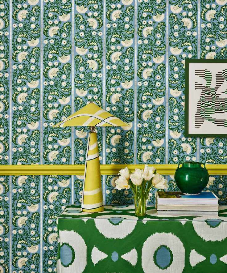 upholstered console with patterned wallpaper, yellow light with pattern shade