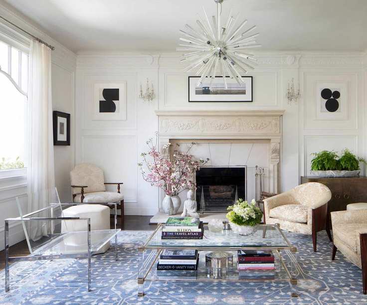 living room with transparent chair and blue area rug and fireplace