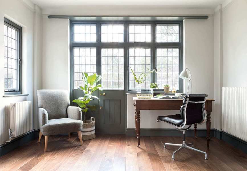 Office with desk, chair and armchair and wood floor