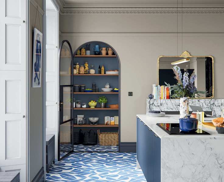 Large kitchen with kitchen island, curved archway door leading to pantry