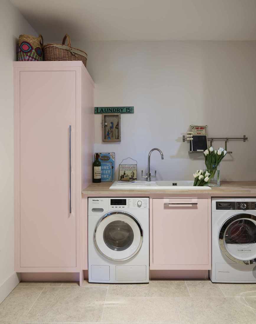 A pale pink utility room.
