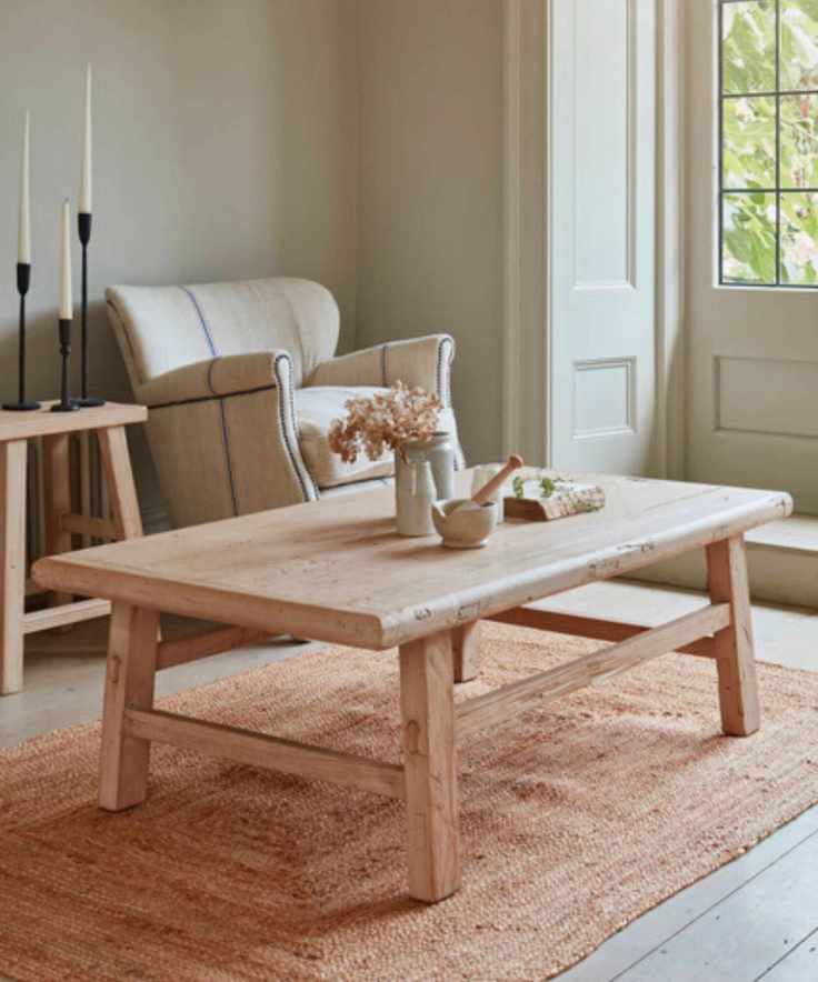 A natural living room with a reclaimed wood table