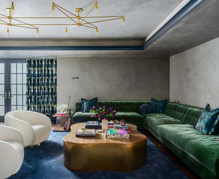 living room with green sofa and low furniture and large ceiling light