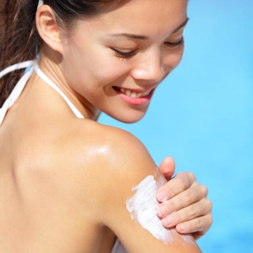 Woman applying sunscreen