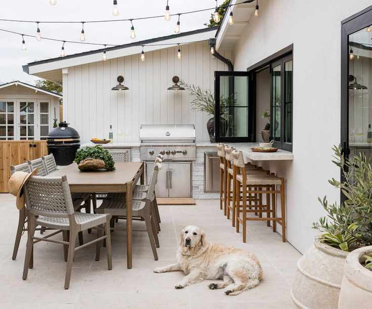 Outdoor dining area with barbecue and kitchen hatch