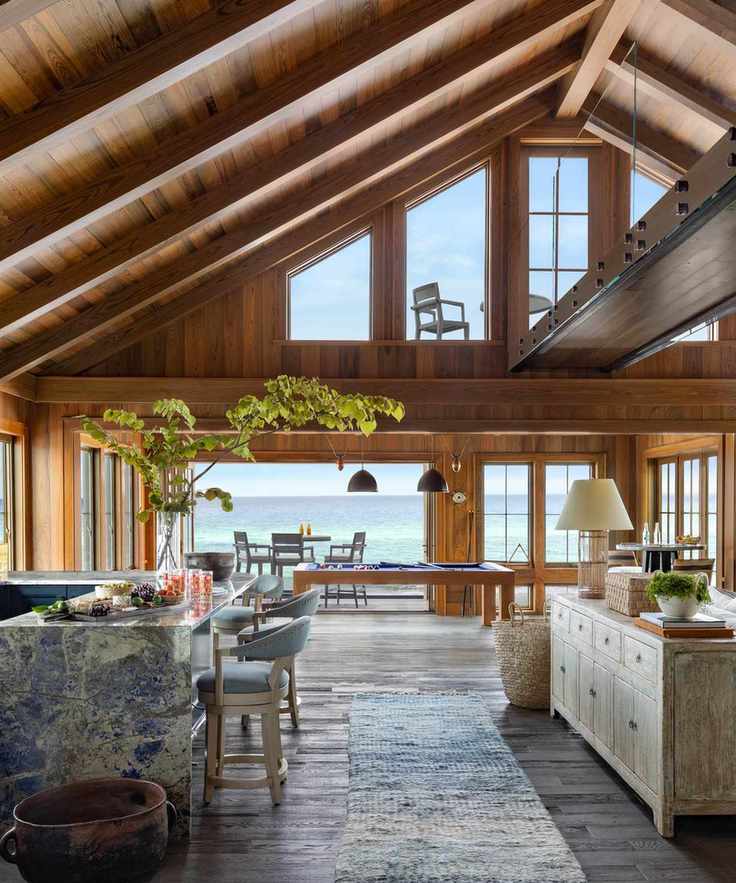 Double height space with seating and dining areas and view to ocean