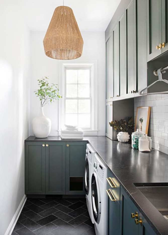 L-shaped small laundry room with blue and white cabinetry.