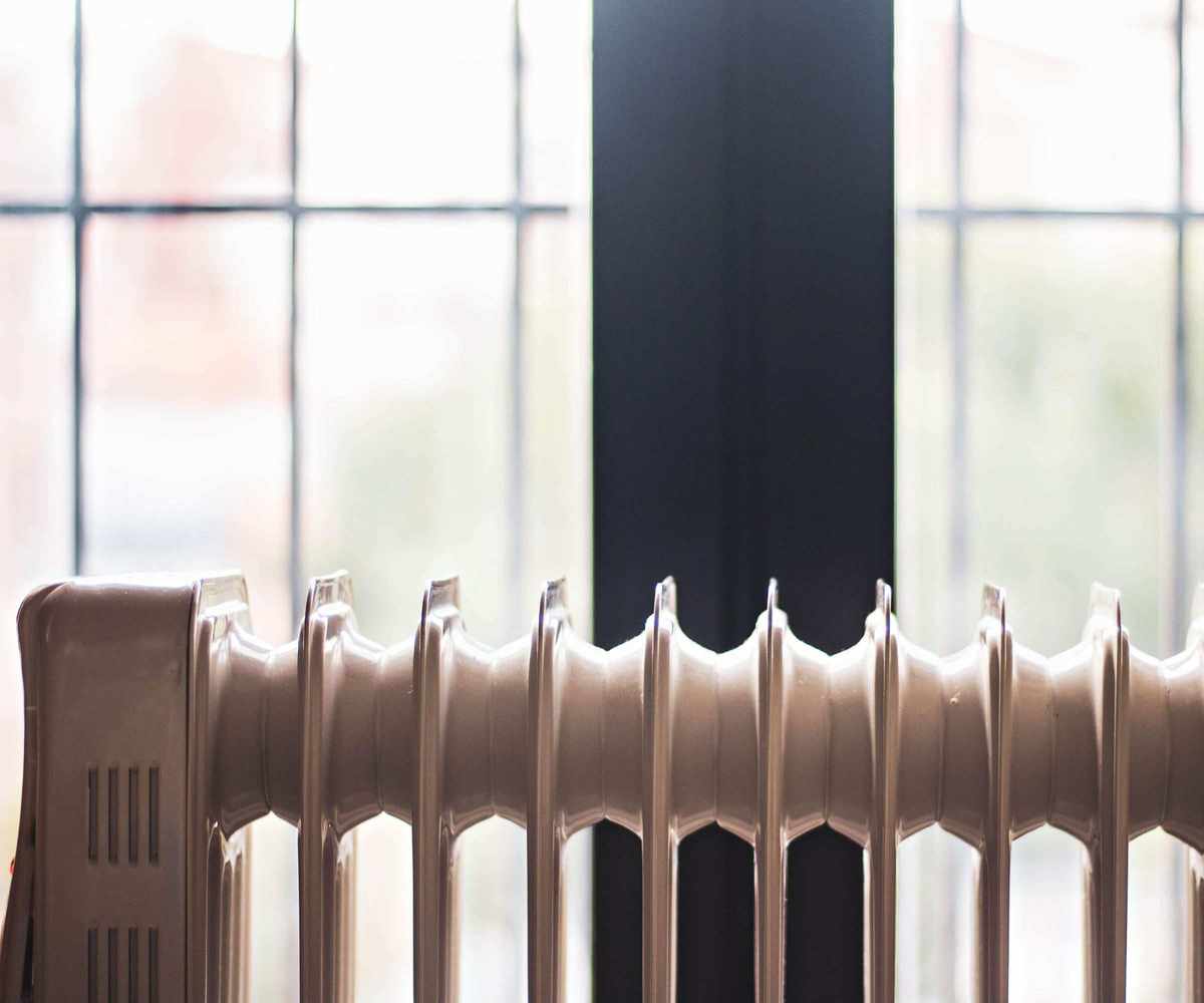 An electric heater in front of a window