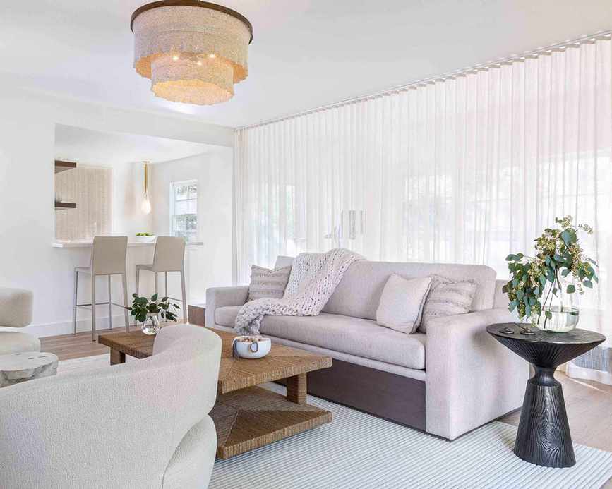 Stylish pool house featuring neutral interiors with seating and breakfast bar.