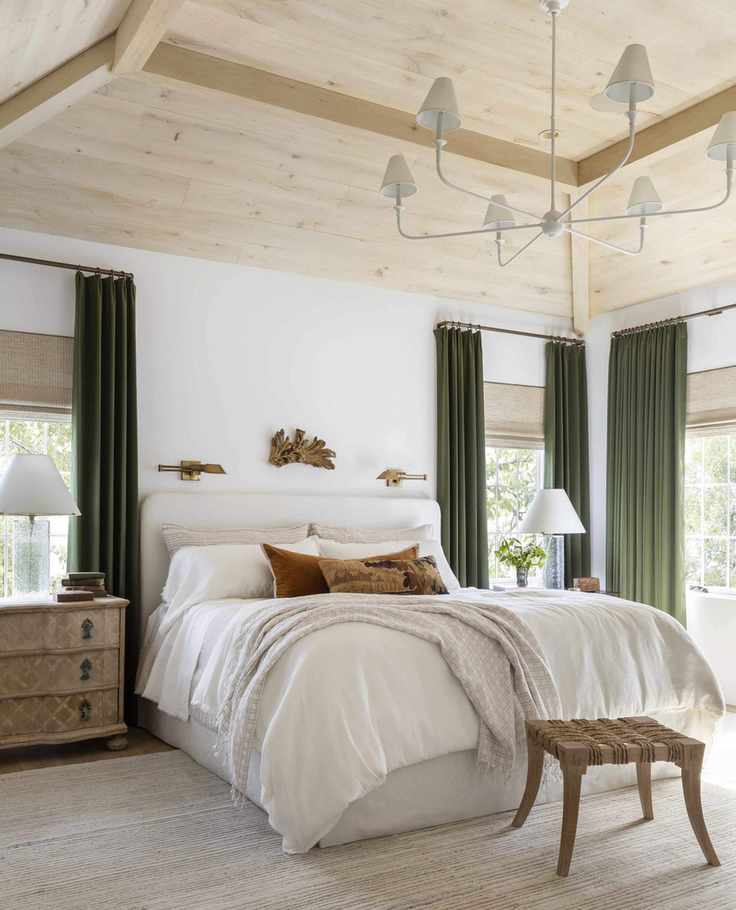 Luxury bedroom with neutral scheme and green velvet curtains