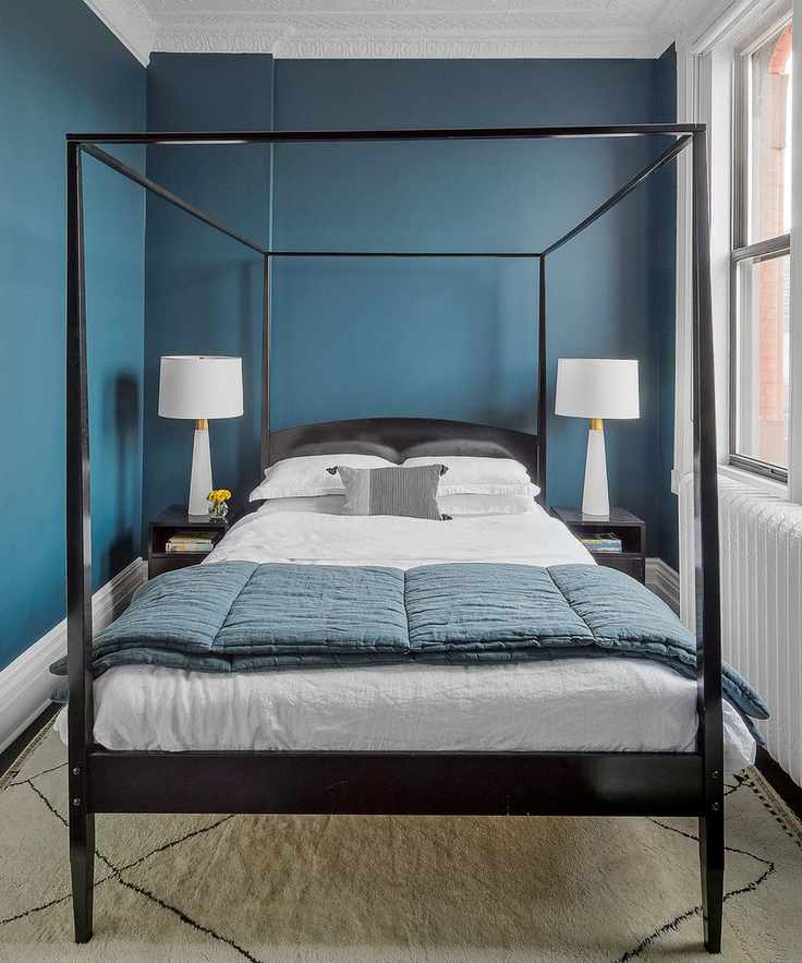 Box bedroom ideas in a room with blue walls and a four poster bed.
