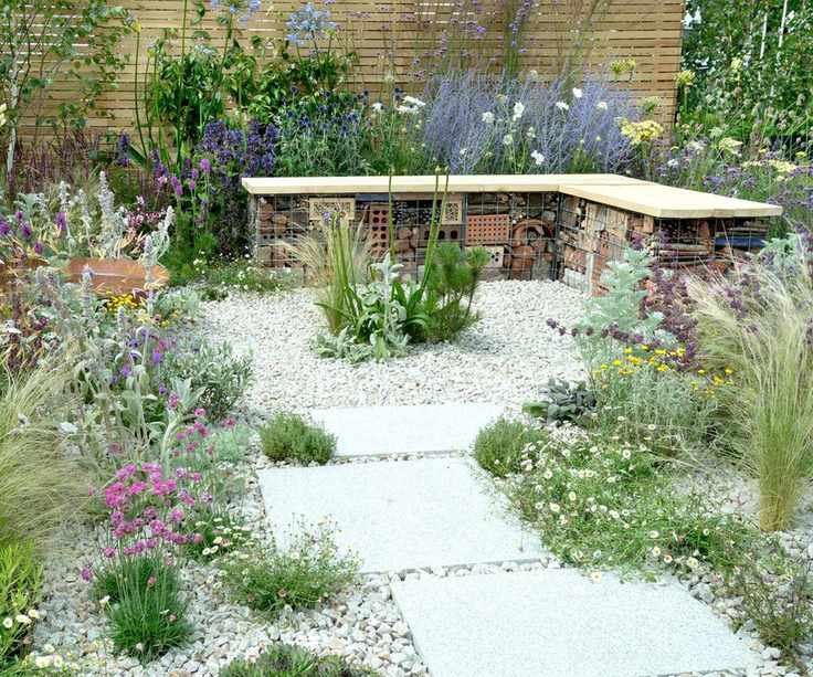 gravel patio featuring wildlife garden bench and natural planting