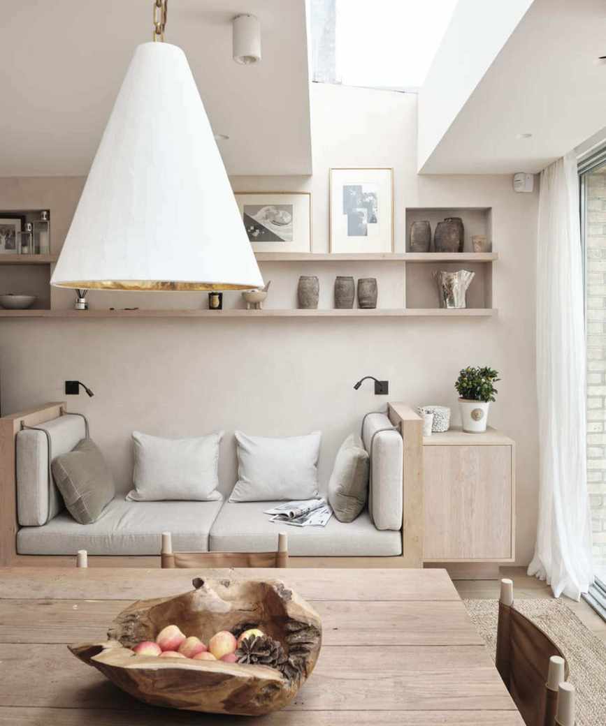 neutral room with sofa and wooden dining table