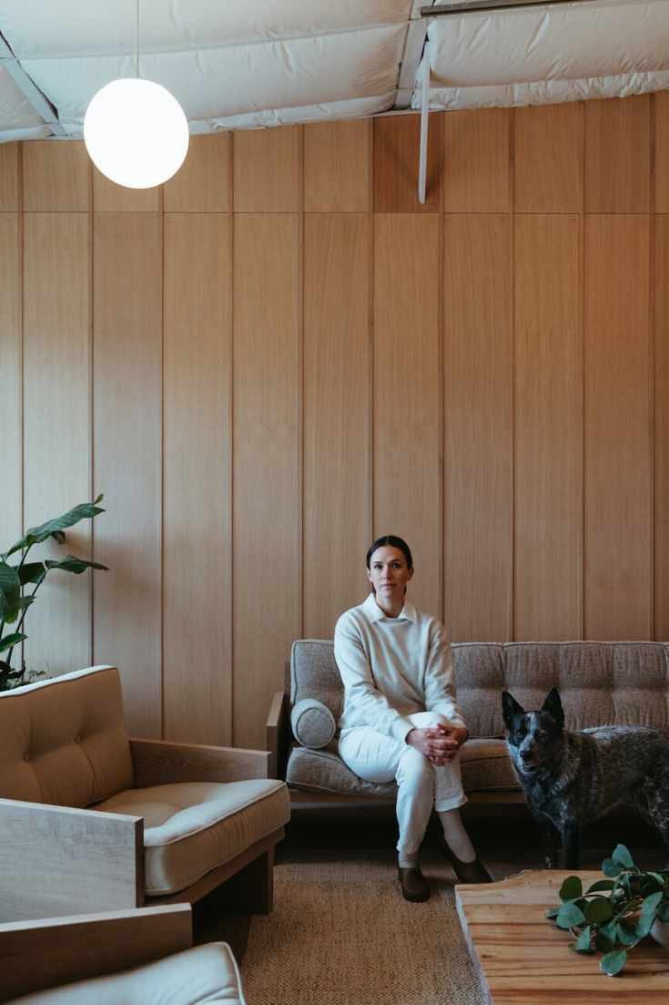 Adriene Mishler with her dog in her office.