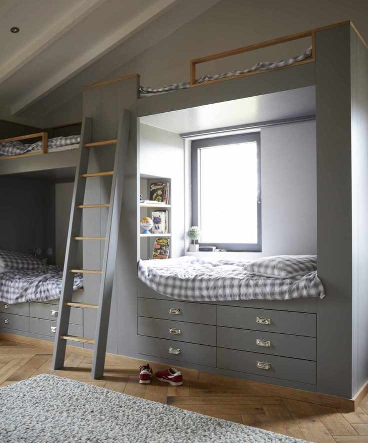 A kids' room featuring two double loft beds in a cozy design