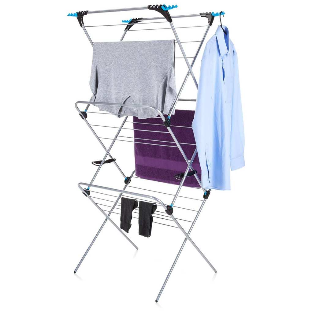 A clothes airing rack with a grey top, two black socks, a purple towel and blue shirt hanging on it