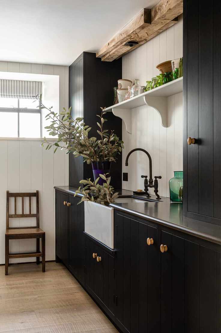 Utility room with a wooden chair and dark cabinetry