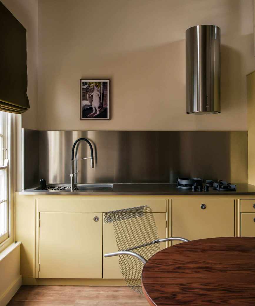 Yellow kitchen with stainless steel accents