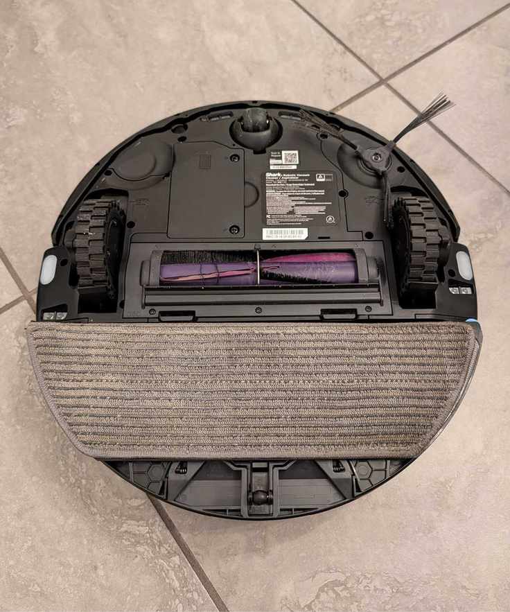 Bottom of the Shark PowerDetect UV Reveal showing the mopping pad, brushes, and wheels.