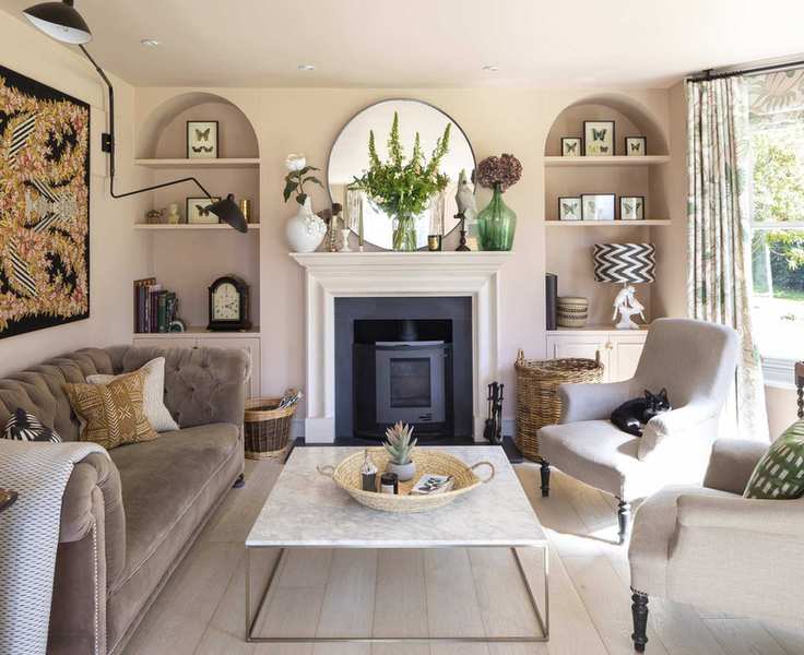 Neutral living room with a cozy velvet sofa and taupe chairs.