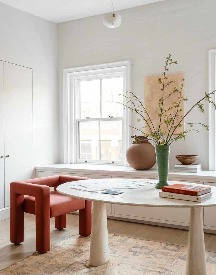 Home office by Athena Calderon with large green vase