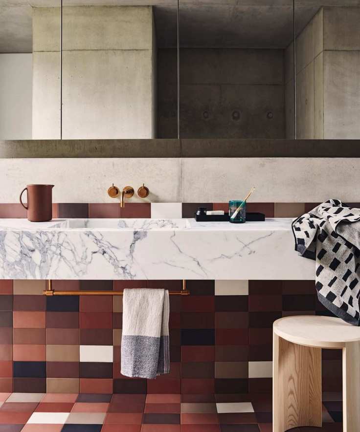 Midcentury bathroom showcasing a marble vanity and brown floor tiles