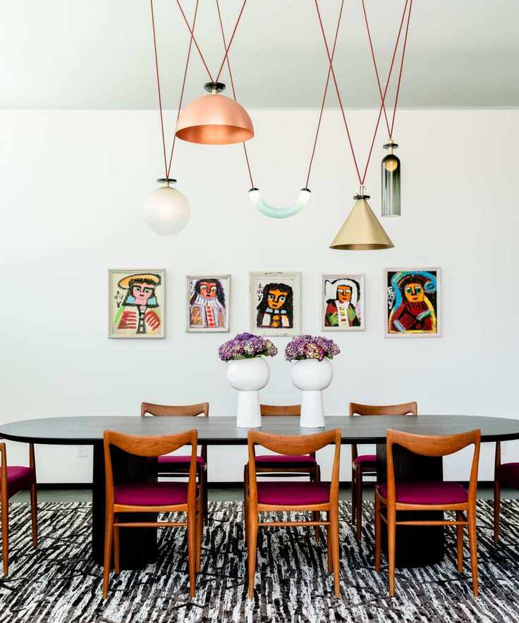 Dining room featuring dark wood chairs and a variety of pendant lights