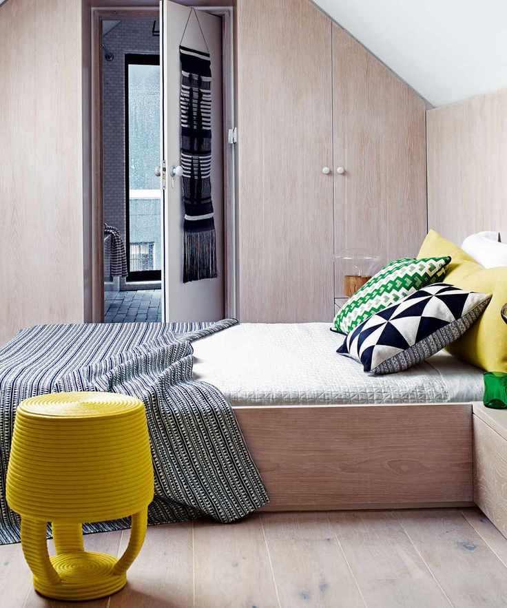 Box room ideas illustrated in a loft space with yellow stool.