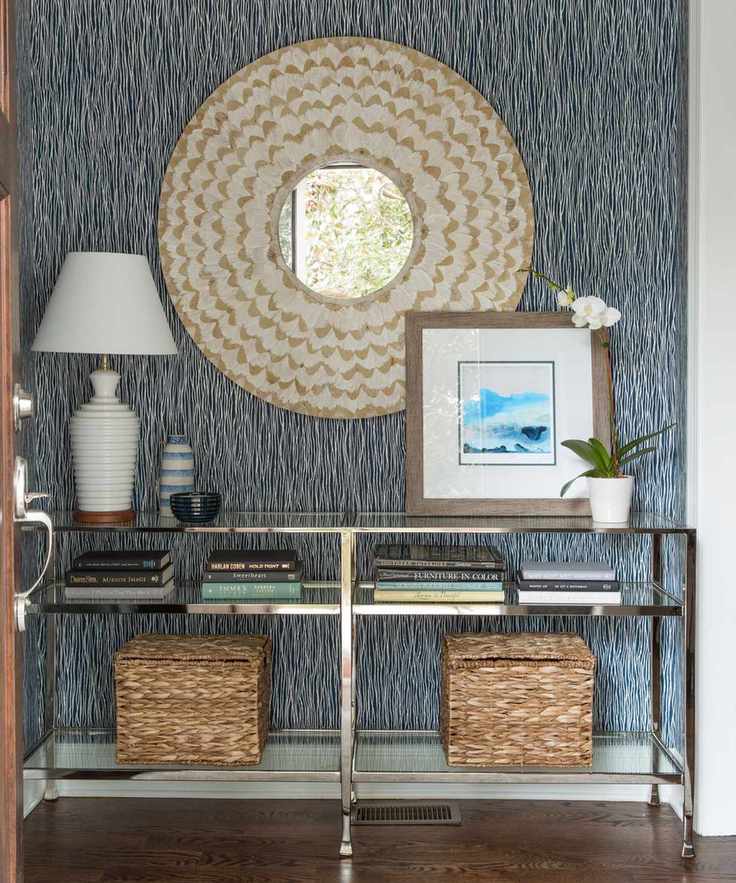 Hallway featuring blue patterned wallpaper and elegant decor