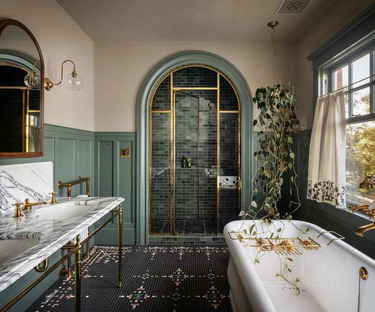 Sophisticated bathroom with muted green and off-white accents.