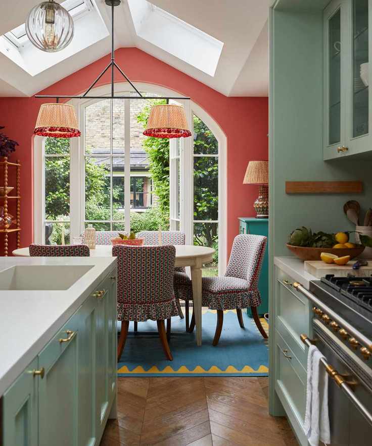 A green kitchen with brass hardware