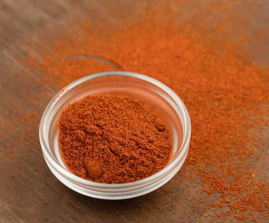 Chili powder on a wooden table