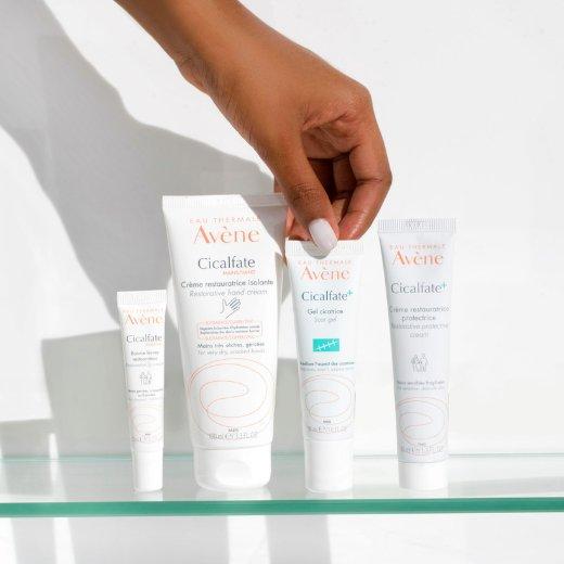 Image of hand model picking up a bottle of Avene Cicalfate