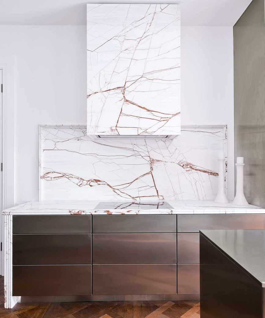 Marble extractor hood in white kitchen