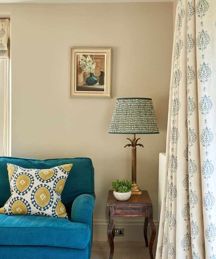 A sitting room featuring bright blue furnishings and Slaked Lime painted walls.