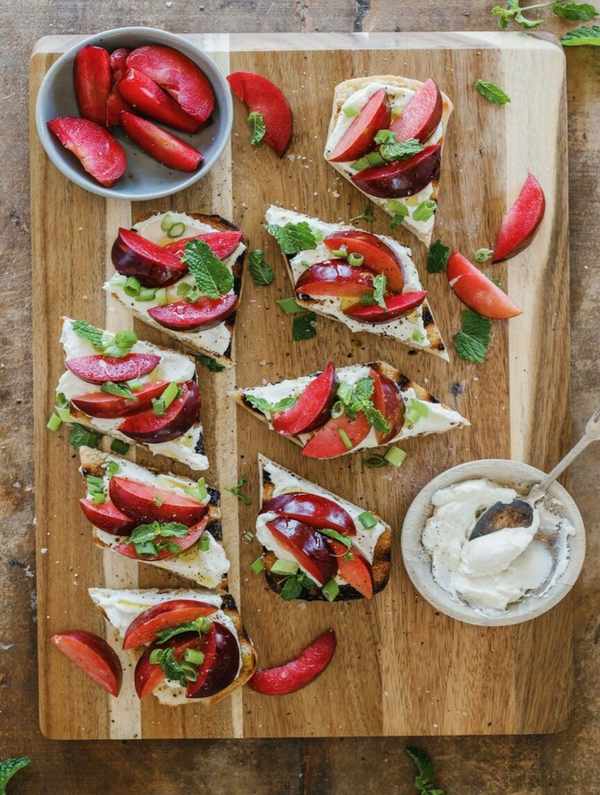 ricotta and plum bruschetta on serving board
