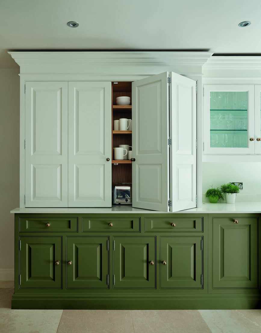 green and white kitchen with green units and white painted cabinetry