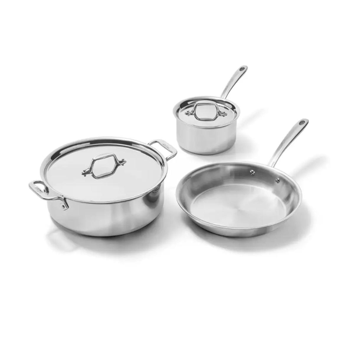 A set of three stainless steel pans: a stock pot with lid, a sauce pan with lid, and a small frying pan.