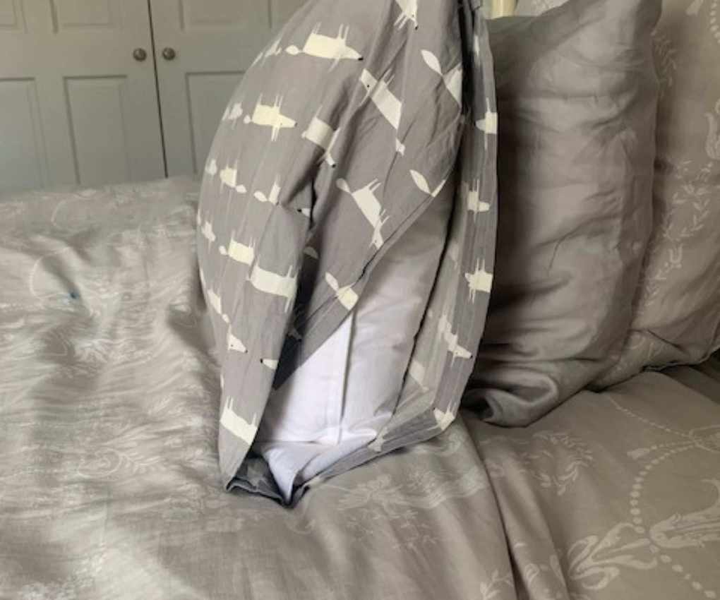 The Brooklinen Down Pillow in a pillowcase, from the side